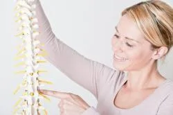 woman holding spine