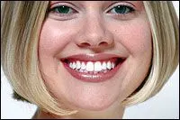 blond girl smiling with whiter teeth after teeth whitening treatment Huntsville, AL dentist