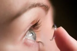 woman putting in contact lenses