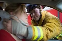Firefighter in Birmingham helping a young female in an auto accident 