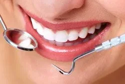 dental tools around woman's smiling mouth, nice teeth, cosmetic dentistry Westminster, MD
