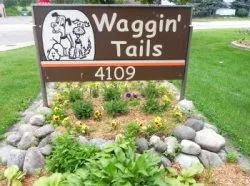 Waggin_Tails_sign_with_flowers.jpg