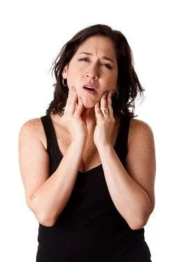Woman holding jaw in pain, needs TMJ treatment Edison, NJ