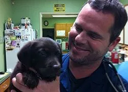 doctor with a black puppy