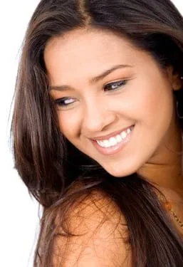 young beautiful dark haired woman looking over shoulder, smiling nice white straight teeth. cosmetic dentistry Decatur, IL