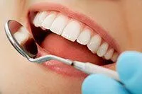 dentist hand with dental mirror examining woman's teeth, dental crowns Sandy, UT