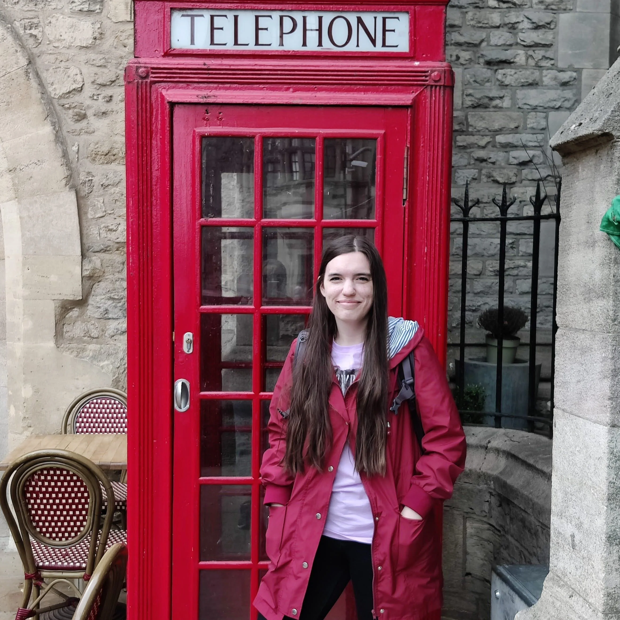 Erica pictured in front of a phone booth