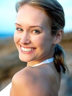 blond woman at beach smiling nice teeth after cosmetic dentistry Los Angeles, CA cosmetic dentist Beverly Grove Los Angeles