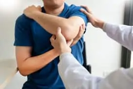examining patient's elbow