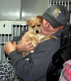 Valencia County Rescue Brian Spence holding rescued dog