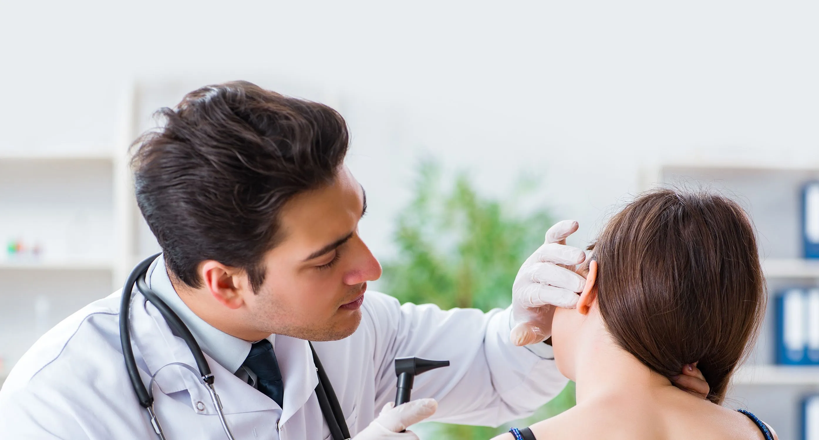 Doctor examining patient's ear Doctor examining patient's ear