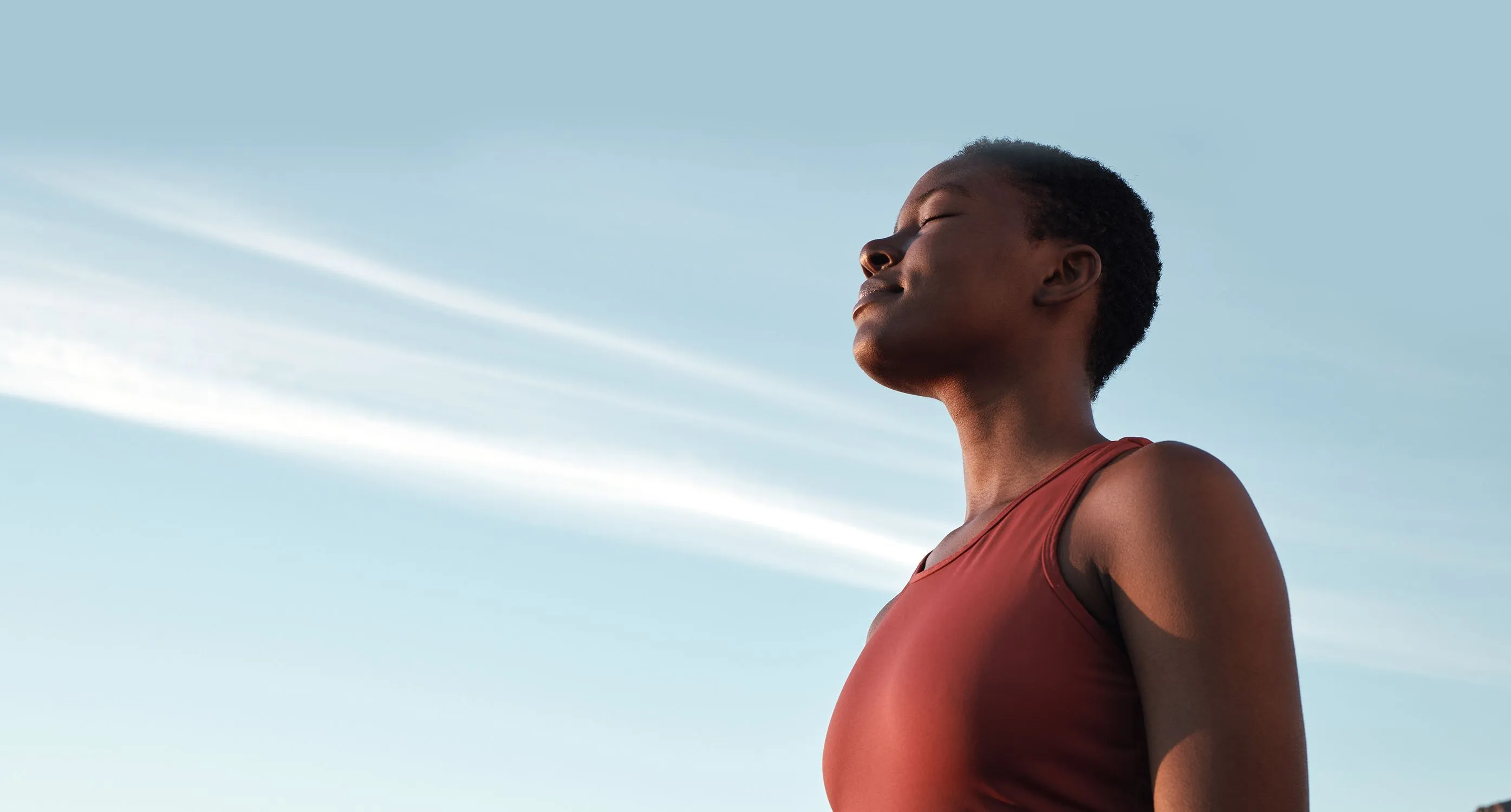 Woman breathing deeply with eyes closed Woman breathing deeply with eyes closed