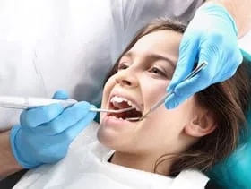 young girl getting dental work done on teeth by family dentist Katy, TX