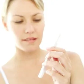 Woman taking pregnancy test