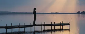 Individual person on a pier at sunset