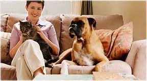 getty_rf_photo_of_woman_on_sofa_with_cat_and_dog.jpg