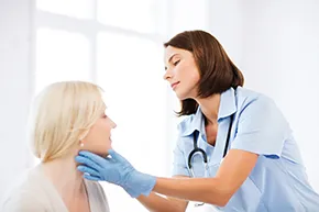 Doctor checking patient's neck