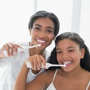 Mother brushing their teeth