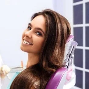 beautiful dark haired woman smiling, sitting in dental chair, Hilo, HI dentist