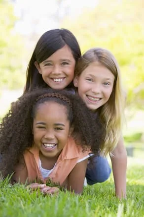 three young girls outside laughing, kids dentist Frederick, MD pediatric dentistry 