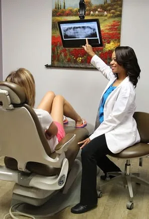 Dr. Reed, Female Dentist in Alvin TX, with patient
