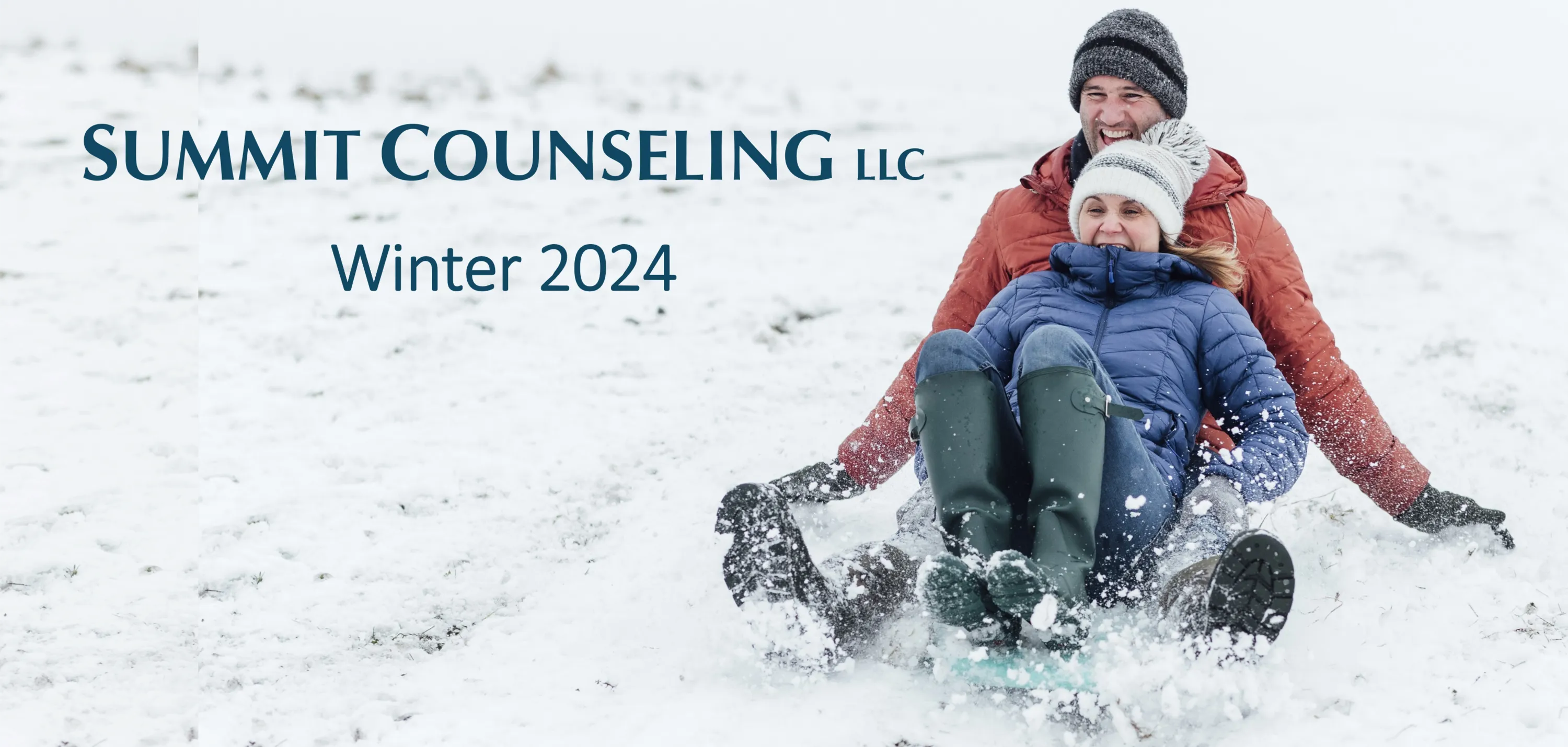 Couple sledding on a hill