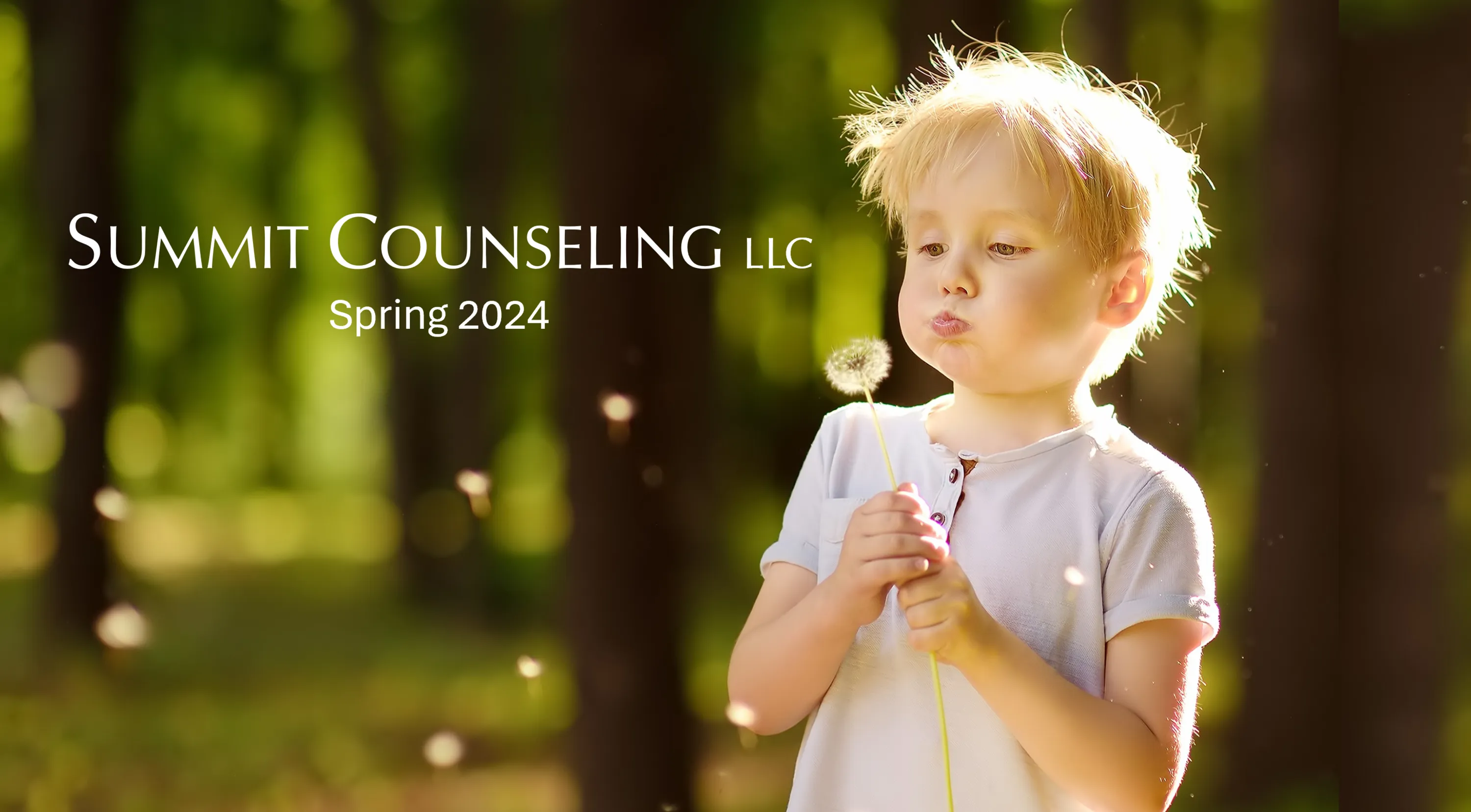 Young boy blowing dandelion fluff.