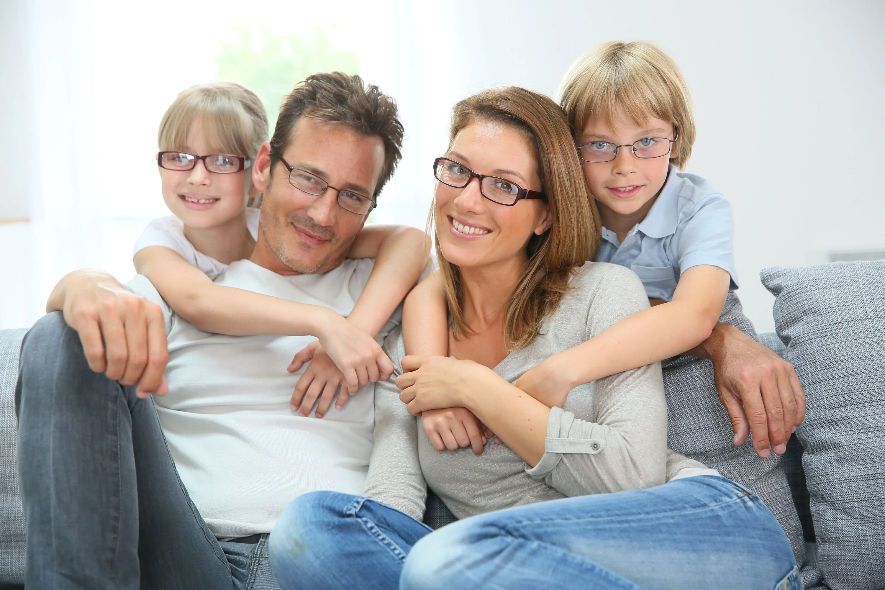 a family with eyeglasses posing for a picture