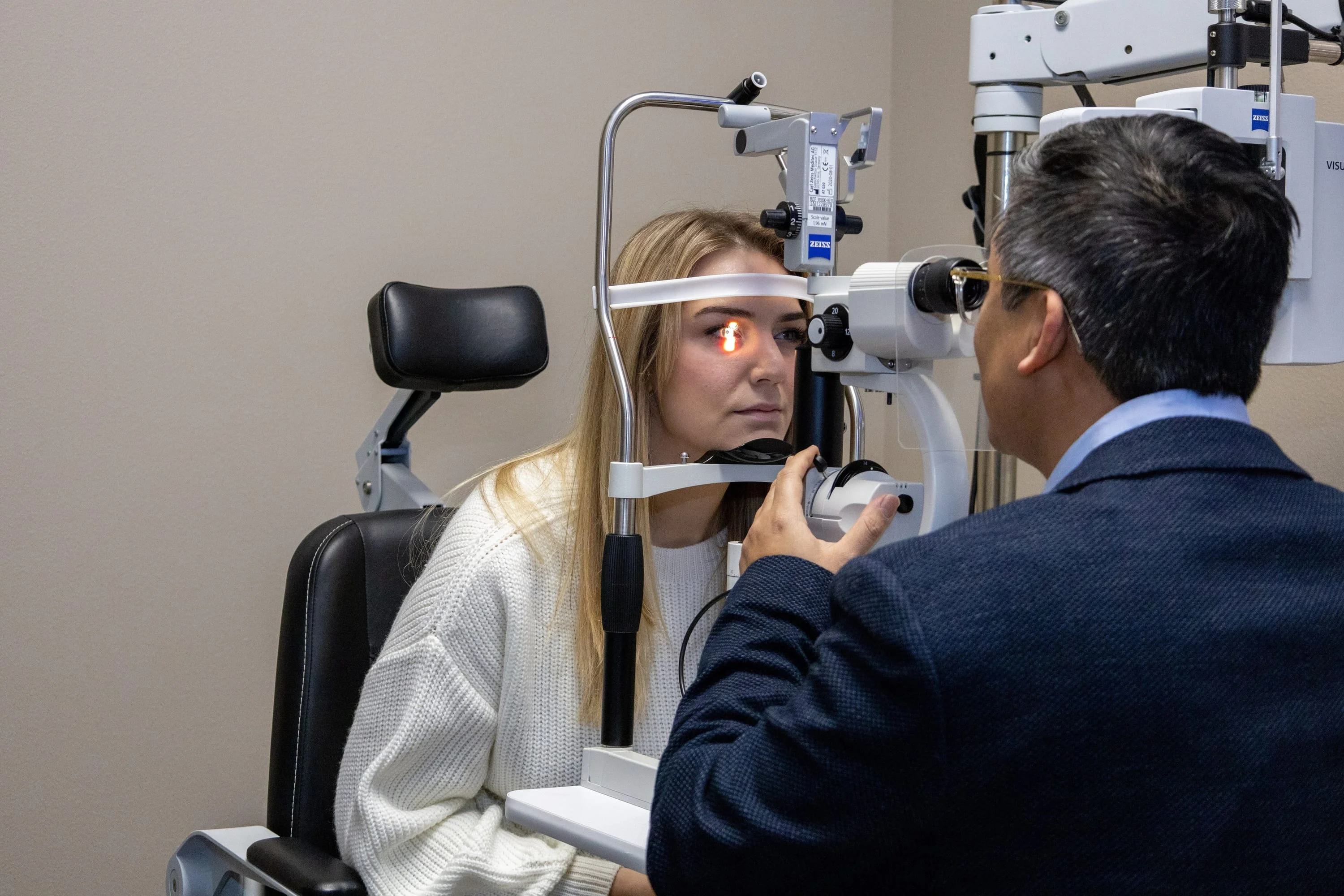 a person sitting in a chair getting an eye exam