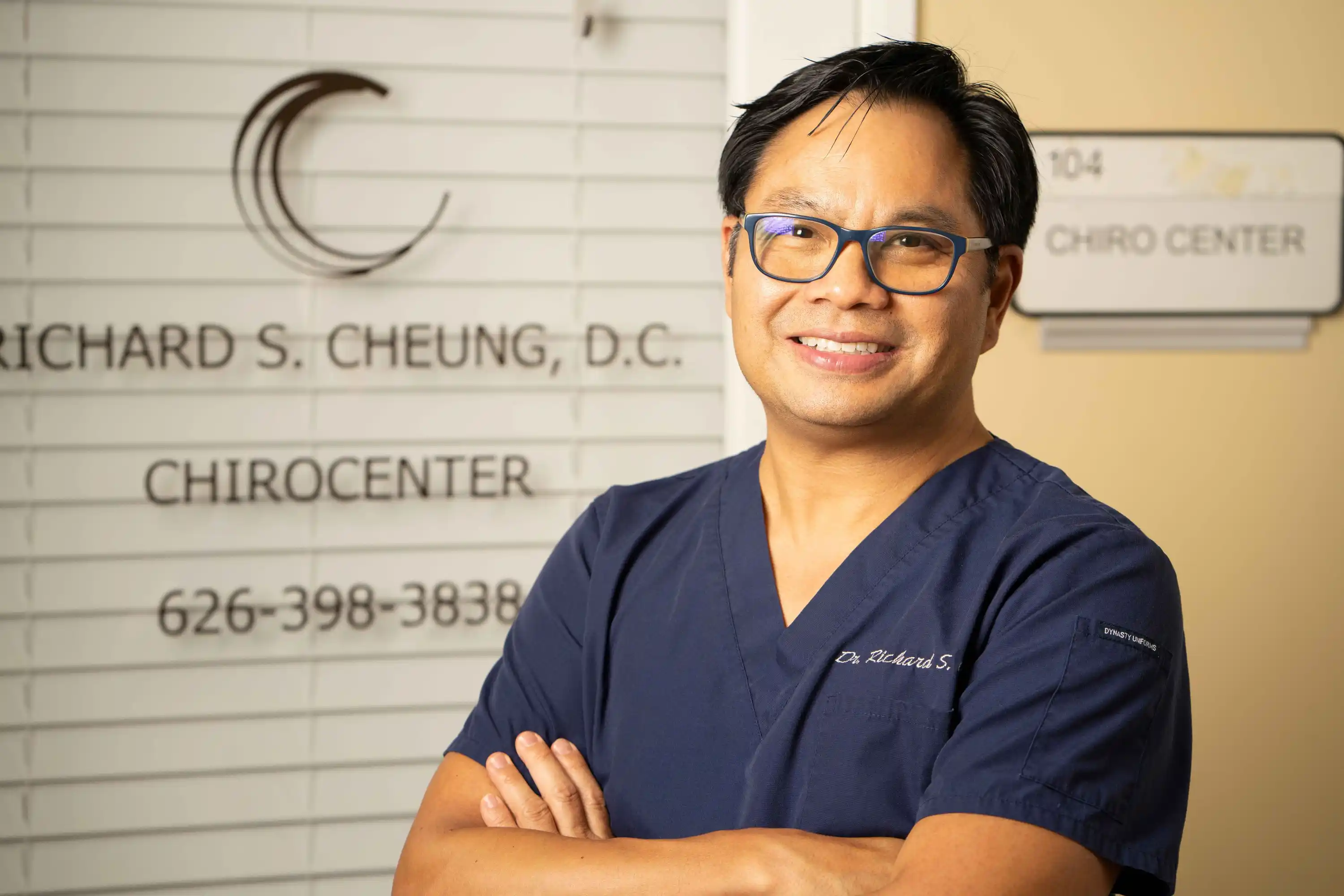 photo of dr cheung in front of clinic