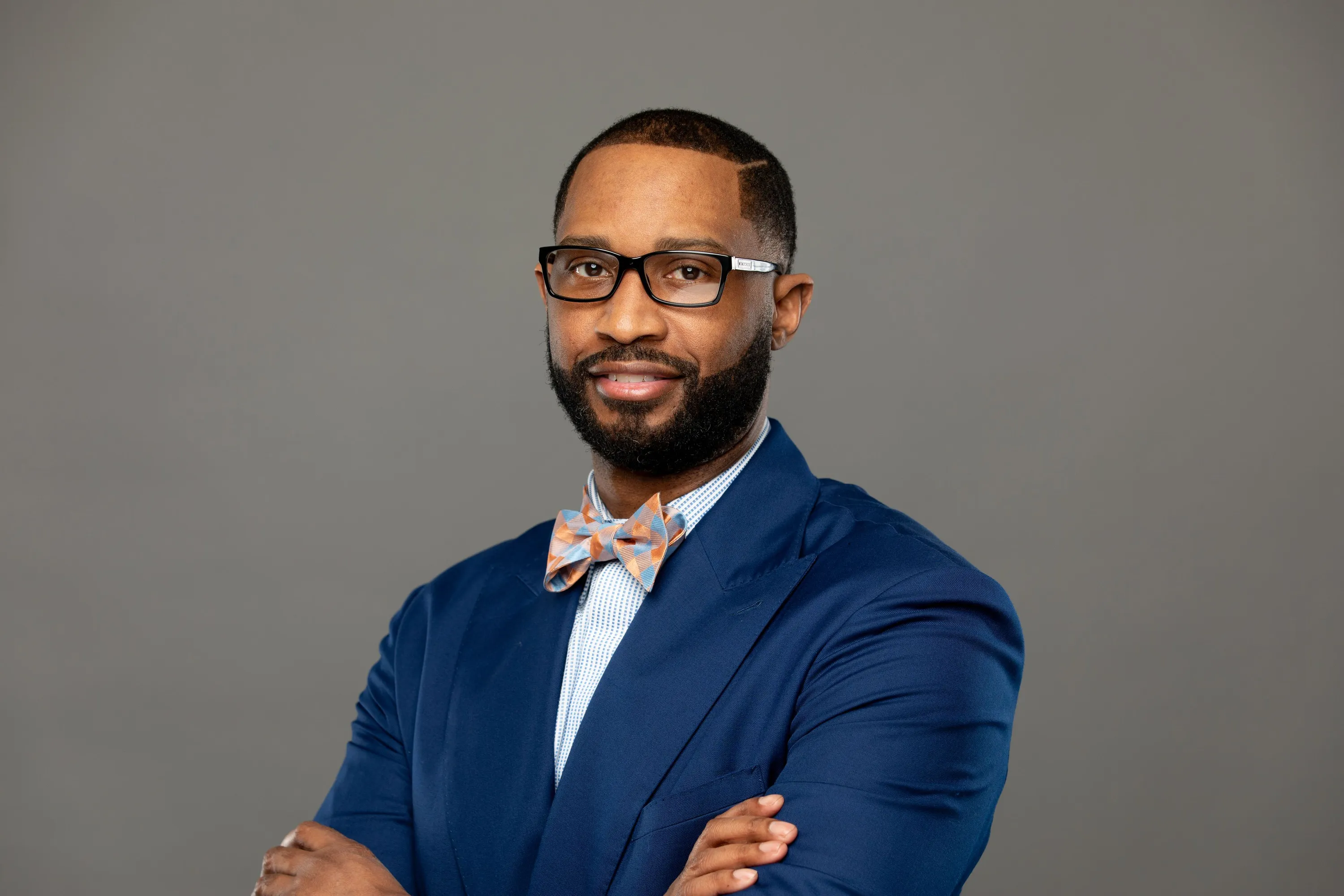 Headshot in blue and glasses