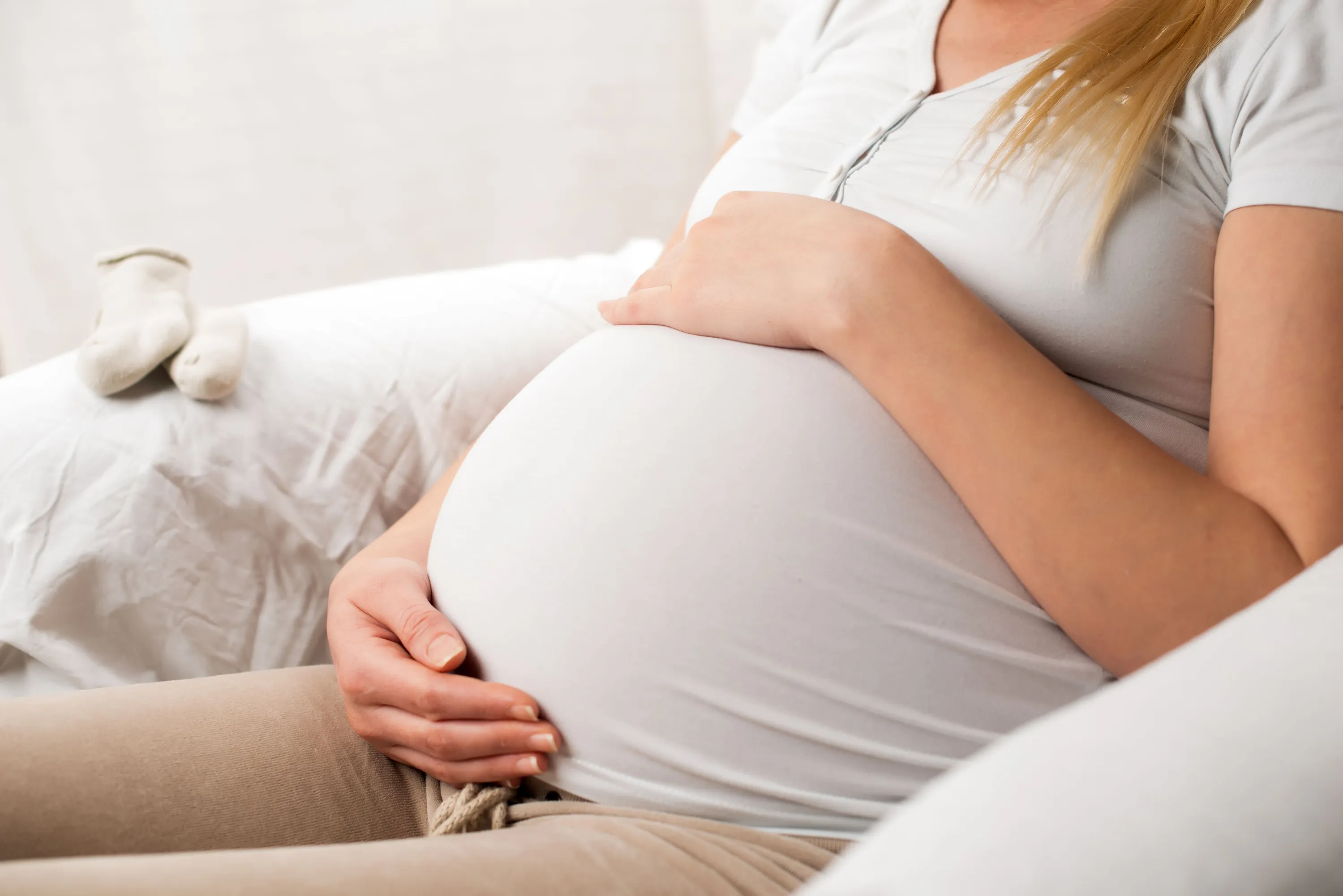 pregnant woman sitting in her home in Dallas