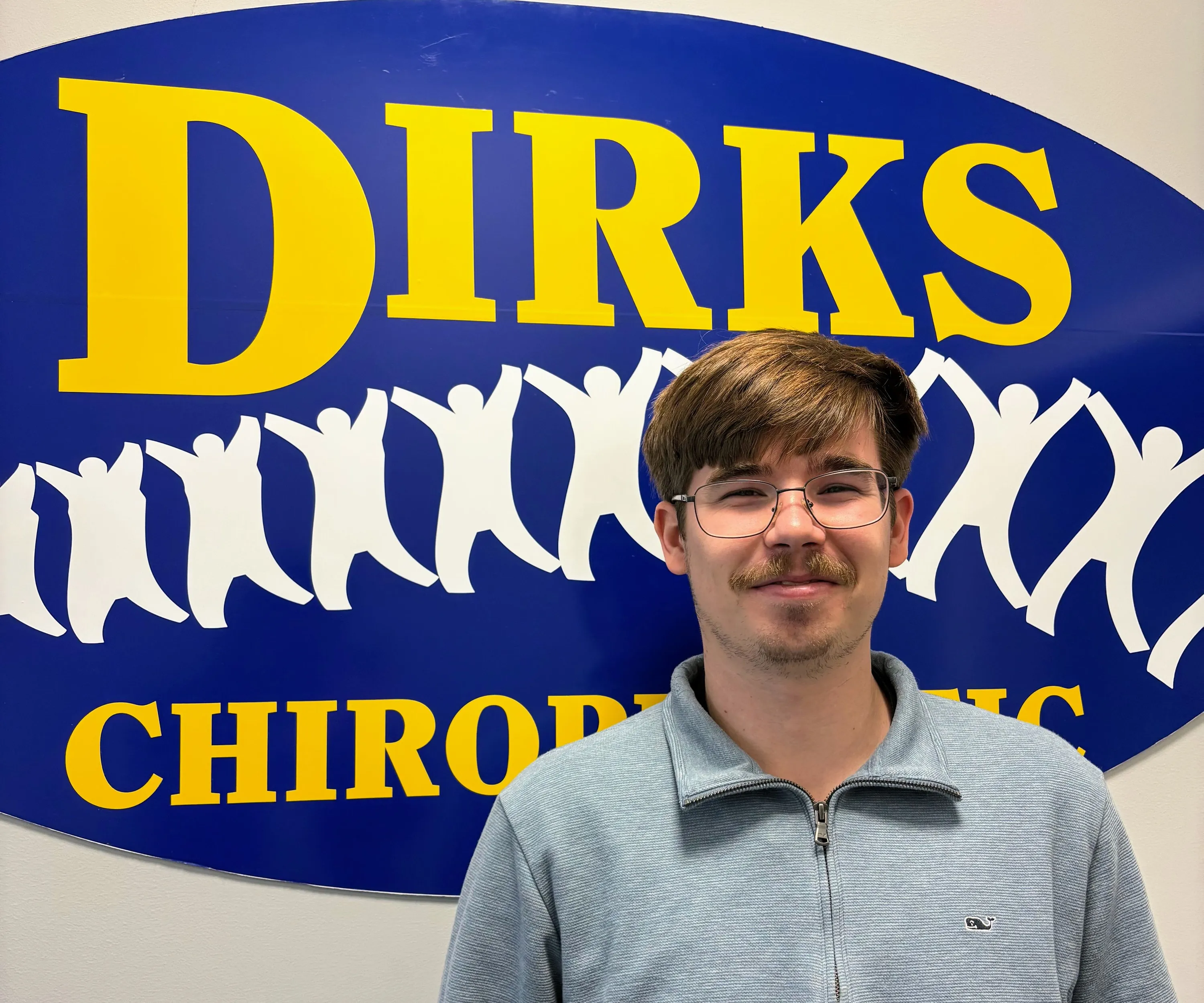 Richard is standing in front of Dirks Chiro sign