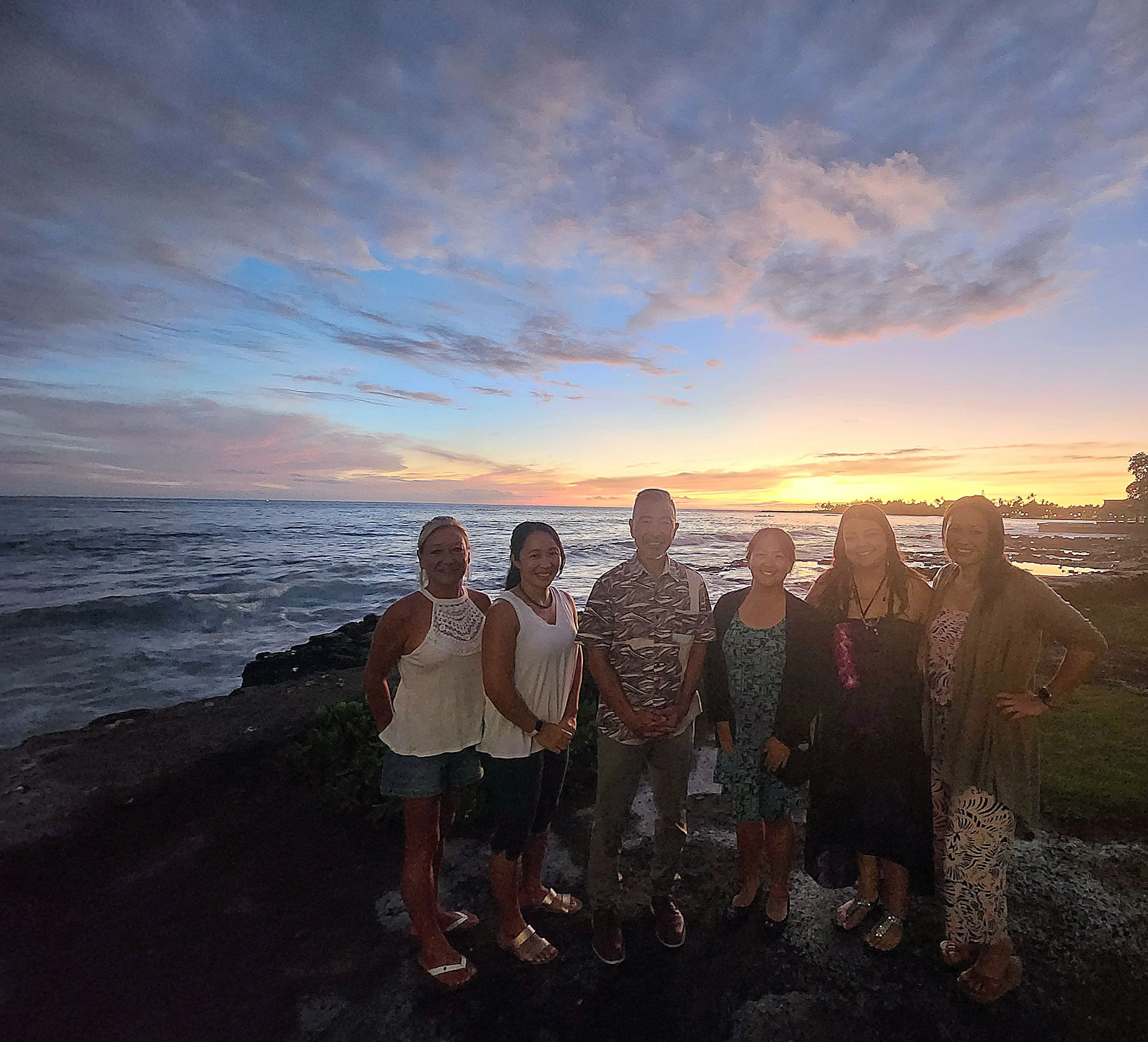 A photo of the staff on the beach at sunset