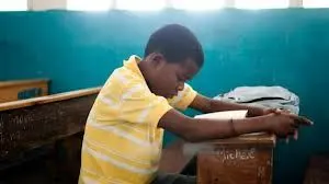 Boy Reading at Desk