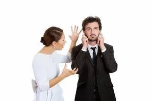 Woman arguing with man covering his ears