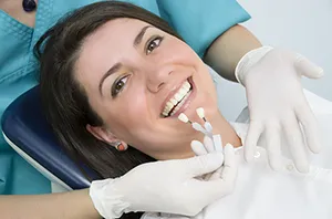 woman smiling in dental chair getting Teeth Whitening treatment Arlington, VA Dentist 
