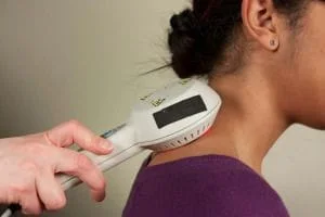 cold laser being used on a patients neck