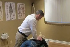 doctor cracking patients lower back