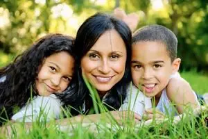 Woman and two children smiling