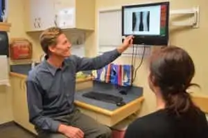 Dr. Sherrill explaining knee treatment options in clinic