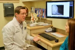 Dr. Wright shows patient x-rays and discusses treatment options