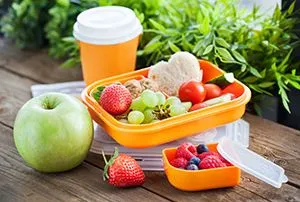 Lunch box for kids with sandwich, cookies, fresh veggies and fruits