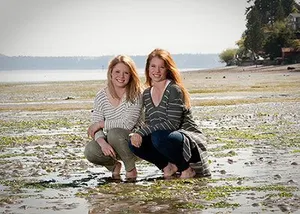 Twin daughters of doctor smiling 