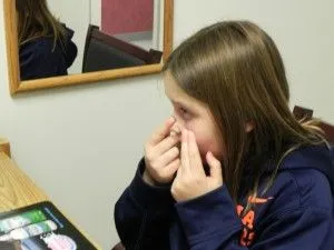 Woman putting Contact Lenses