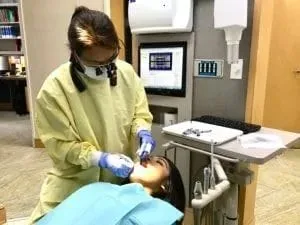 female dental assistant doing dental work in woman's mouth, oral sedation dentist Millbrae, CA