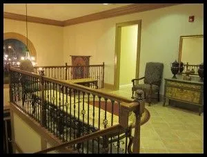 Interior of BridgeMill office. Corner balcony with cushioned benches and chair.