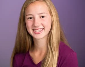 young blond girl wearing traditional braces Fairfax, VA orthodontist