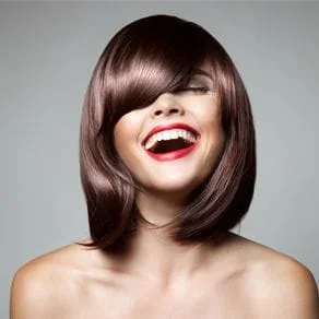 A model with shiny hair laughing