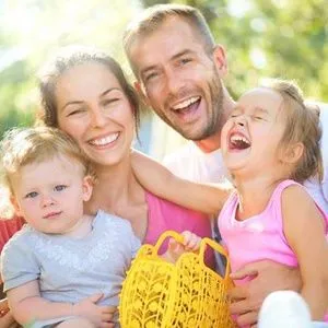 Family smiling in a hammock